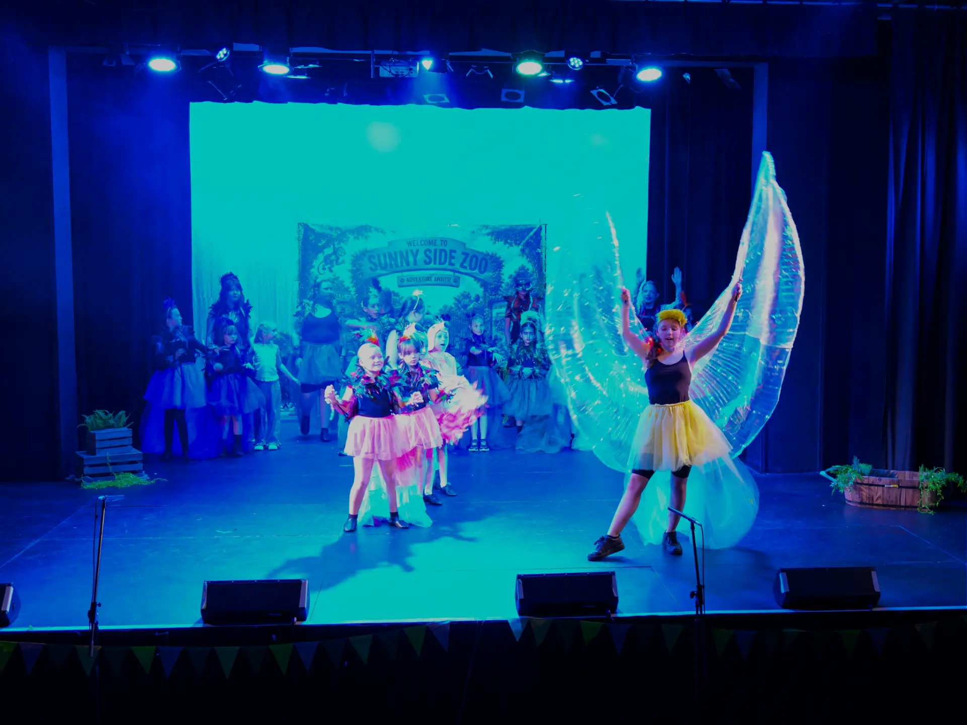 Young performers on stage in a colourful Stage Library production